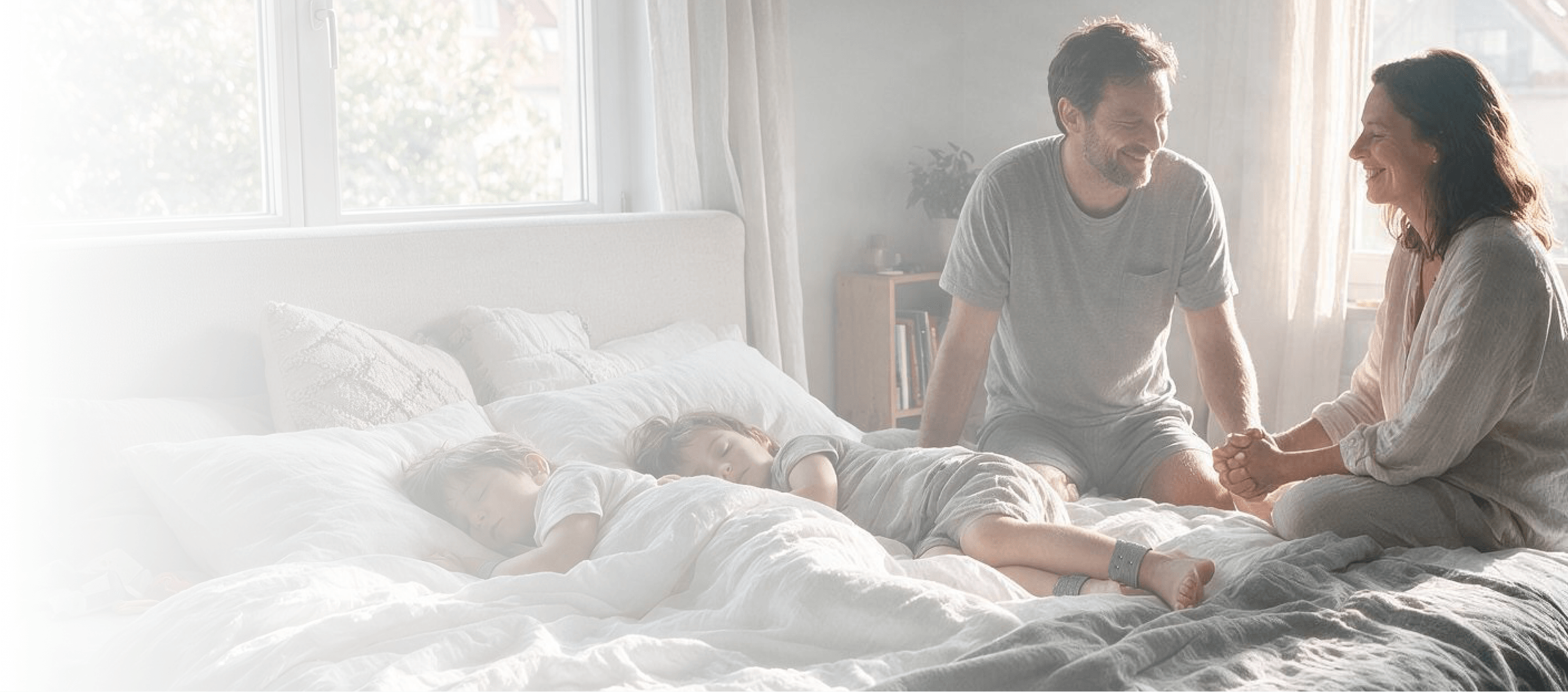 Family in bed at home, child wearing a RestEaze band